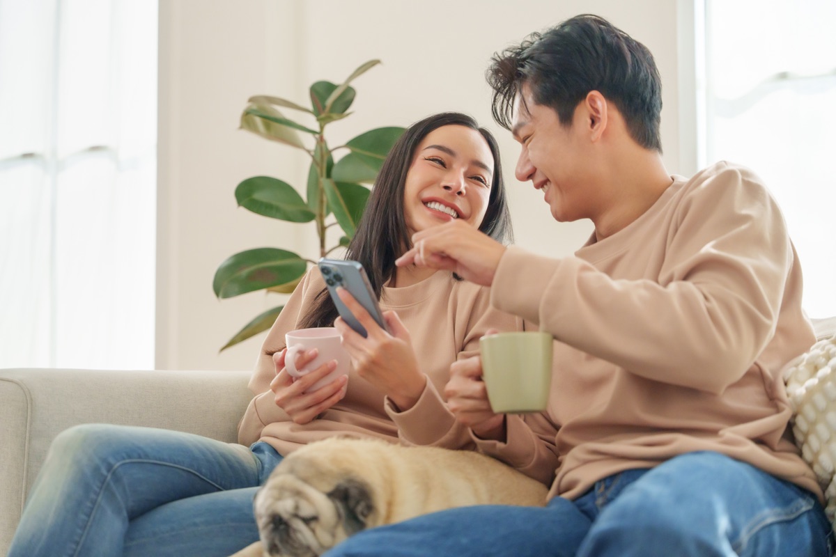 Couple reviewing financial information together on a phone